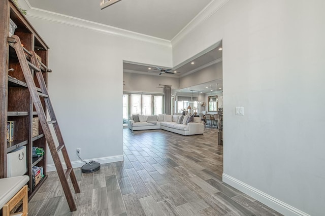 corridor with recessed lighting, baseboards, ornamental molding, and wood finished floors