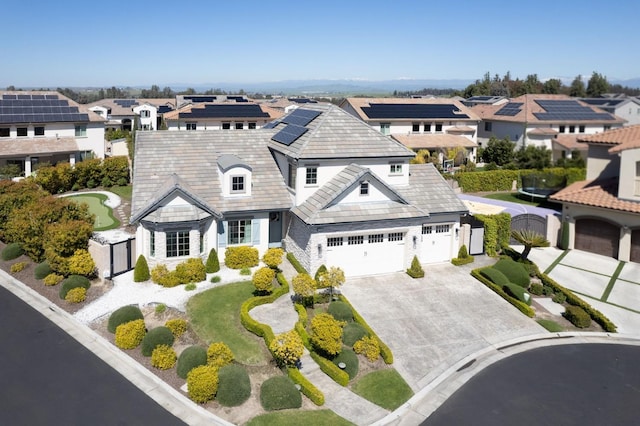 view of front facade with driveway, fence, a residential view, and a gate