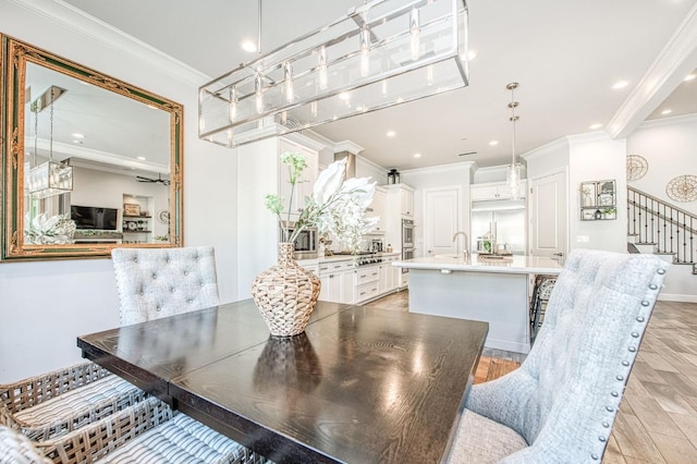 dining area with recessed lighting, stairs, light wood-style floors, and crown molding