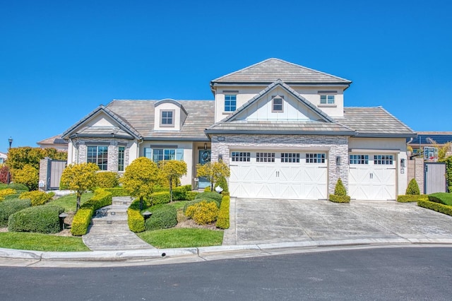view of front of property with driveway, stucco siding, and a garage