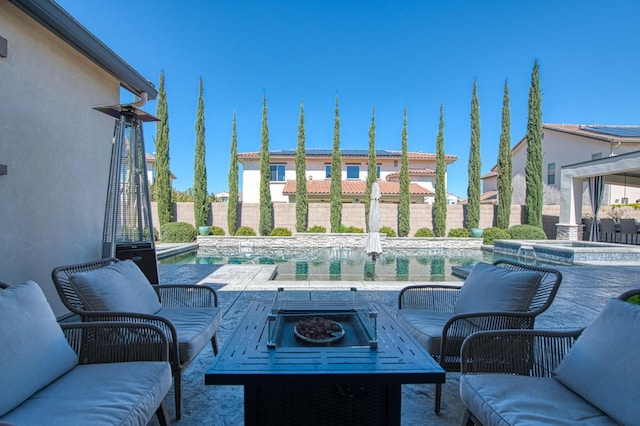 view of patio / terrace with a fenced backyard, an outdoor living space, an in ground hot tub, and a fenced in pool