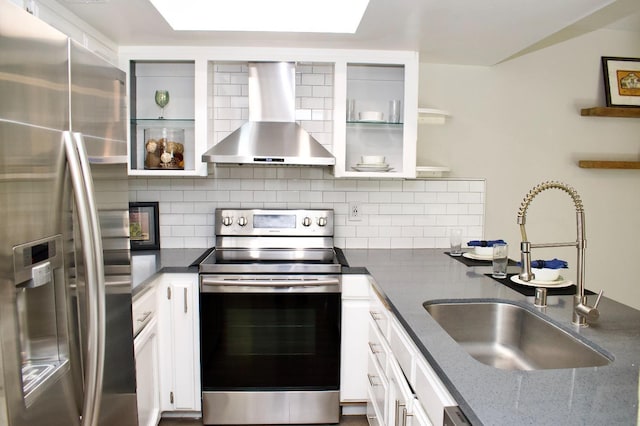 kitchen with appliances with stainless steel finishes, wall chimney exhaust hood, backsplash, and a sink