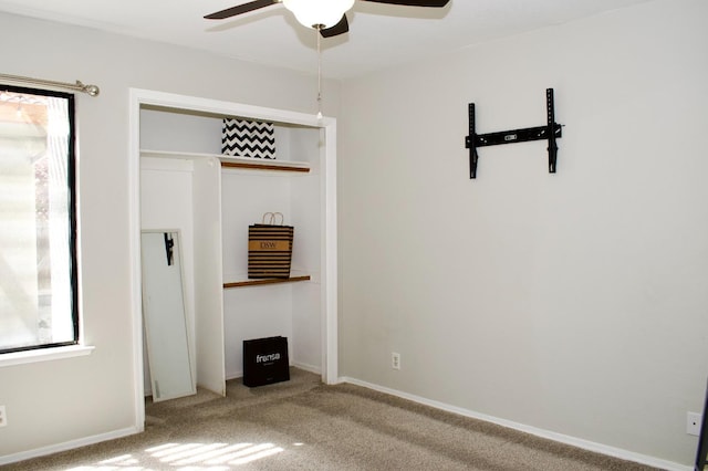 unfurnished bedroom featuring a closet, a ceiling fan, and carpet floors