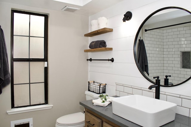 bathroom featuring toilet, visible vents, and vanity