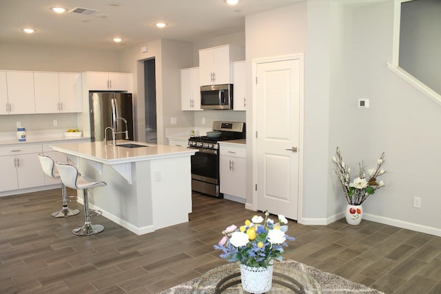 2060 N Walker Ln, Clovis, CA 93619 - kitchen with appliances with stainless steel finishes, a sink, dark wood-type flooring, light countertops, and recessed lighting