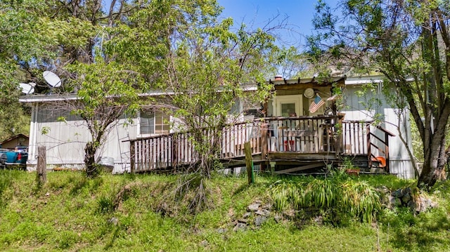 rear view of property with a wooden deck
