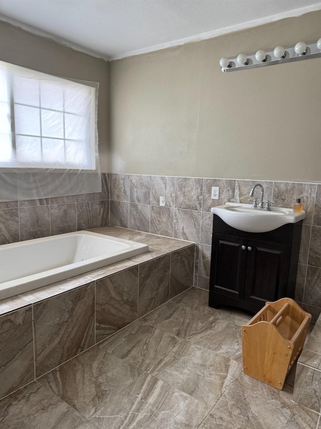 342 N Minnewawa, Fresno, CA 93727 - bathroom with a garden tub, vanity, and tile walls