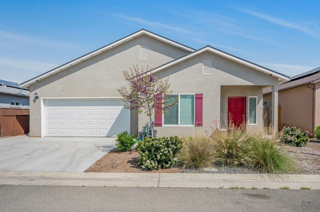 375 Amber Ln, Dinuba, CA 93618 - ranch-style home with a garage, driveway, stucco siding, and fence