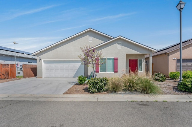 375 Amber Ln, Dinuba, CA 93618 - single story home featuring concrete driveway, stucco siding, fence, and an attached garage
