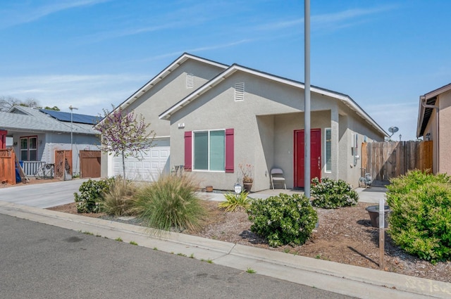 375 Amber Ln, Dinuba, CA 93618 - ranch-style house featuring concrete driveway, fence, a garage, and stucco siding