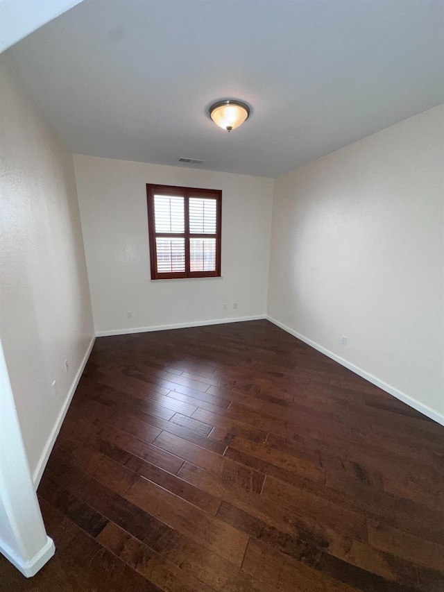 8352 N Shallot Way, Fresno, CA 93720 - spare room featuring visible vents, baseboards, and dark wood-style floors
