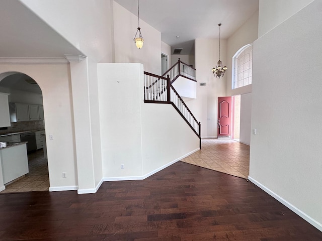 8352 N Shallot Way, Fresno, CA 93720 - entryway with a towering ceiling, baseboards, a notable chandelier, wood finished floors, and stairway