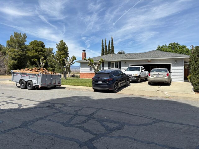 474 Dartmouth Ave, Coalinga, CA 93210 - view of front of house featuring an attached garage, a shingled roof, driveway, and a chimney