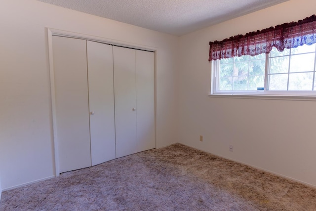 474 Dartmouth Ave, Coalinga, CA 93210 - unfurnished bedroom featuring a closet, carpet floors, and a textured ceiling