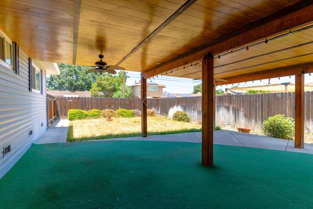 474 Dartmouth Ave, Coalinga, CA 93210 - fenced backyard with a ceiling fan and a patio