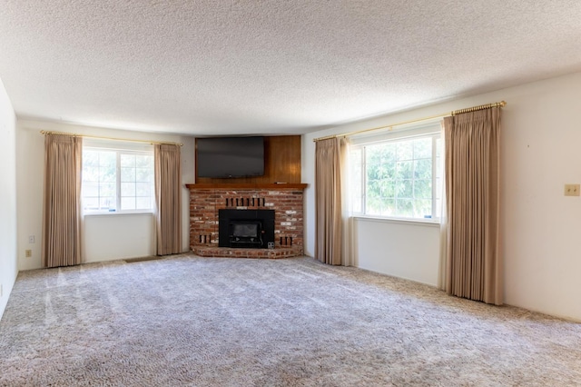 474 Dartmouth Ave, Coalinga, CA 93210 - unfurnished living room featuring a textured ceiling, carpet flooring, and a fireplace