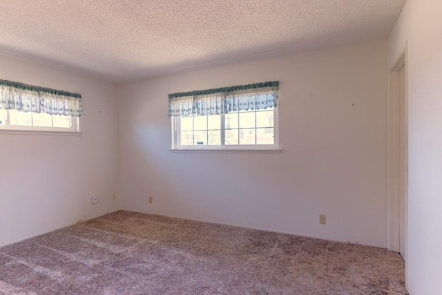 474 Dartmouth Ave, Coalinga, CA 93210 - carpeted empty room with plenty of natural light and a textured ceiling