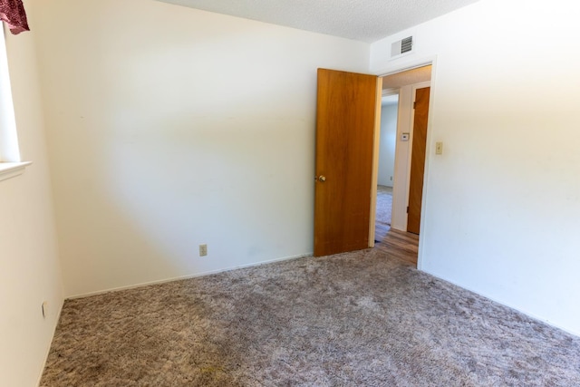 474 Dartmouth Ave, Coalinga, CA 93210 - carpeted empty room with a textured ceiling