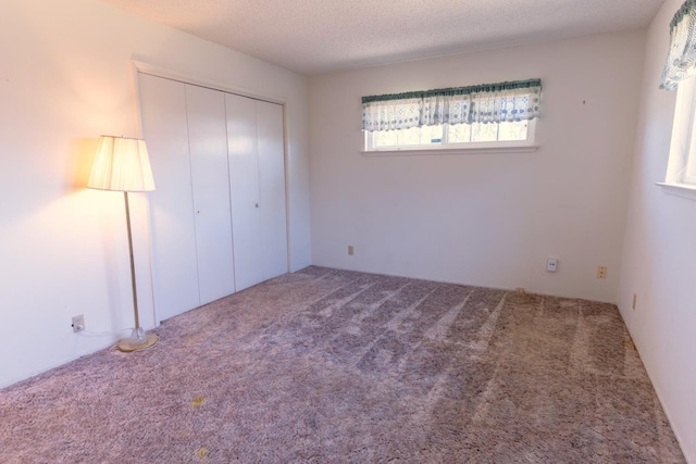 474 Dartmouth Ave, Coalinga, CA 93210 - unfurnished bedroom with a closet, carpet, and a textured ceiling