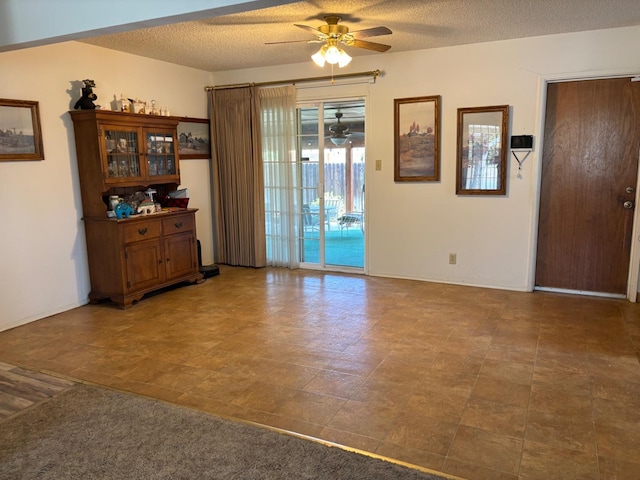 474 Dartmouth Ave, Coalinga, CA 93210 - unfurnished room featuring a textured ceiling, baseboards, and ceiling fan