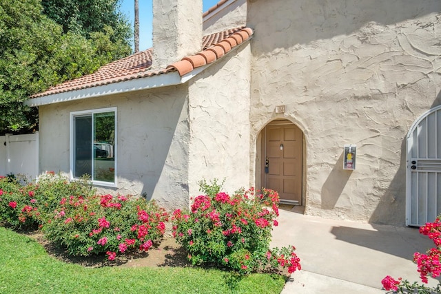 1250 E Shaw Ave Unit 134, Fresno, CA 93710 - property entrance with a tile roof and stucco siding