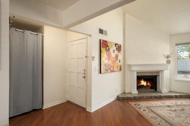 1250 E Shaw Ave Unit 134, Fresno, CA 93710 - living area featuring wood finished floors, a warm lit fireplace, and vaulted ceiling