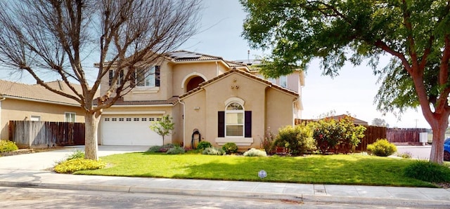 1051 N Coventry Ave, Clovis, CA 93611 - mediterranean / spanish house with roof mounted solar panels, a garage, concrete driveway, and stucco siding