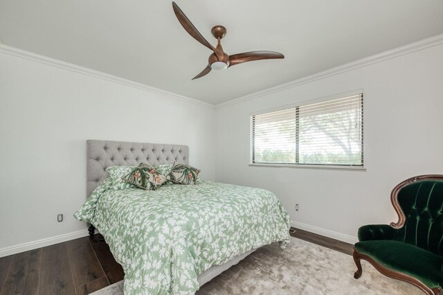 bedroom featuring ornamental molding, baseboards, a ceiling fan, and wood finished floors