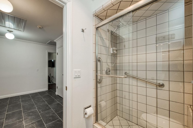 bathroom with a shower stall, baseboards, and crown molding