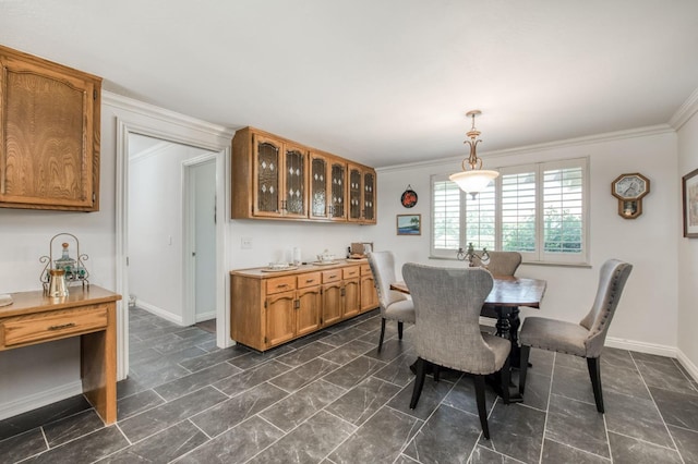 dining area featuring crown molding and baseboards