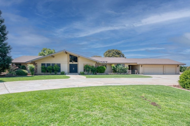 view of front of home featuring driveway, a front yard, and a garage