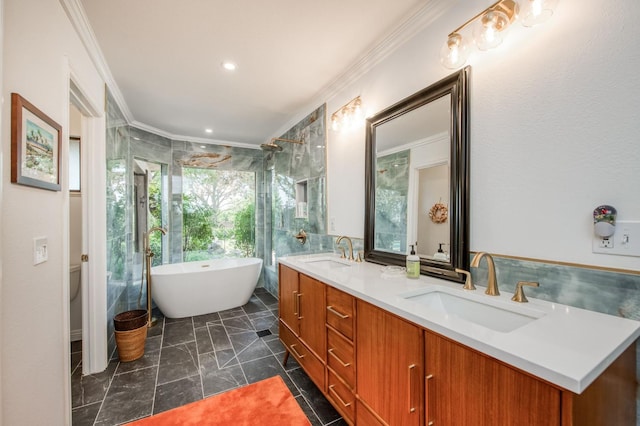 full bathroom with a shower, a freestanding bath, a sink, and ornamental molding
