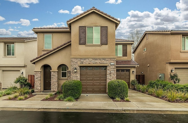 view of front of property featuring stucco siding, driveway, stone siding, a garage, and a tiled roof