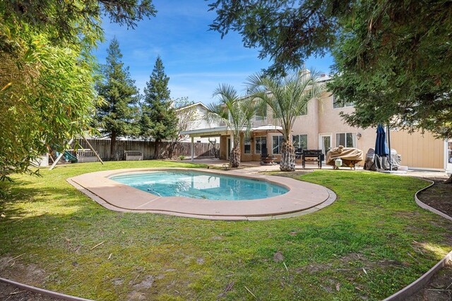 3232 Greenfield Ave, Clovis, CA 93611 - view of swimming pool featuring a fenced backyard, a patio, and a playground