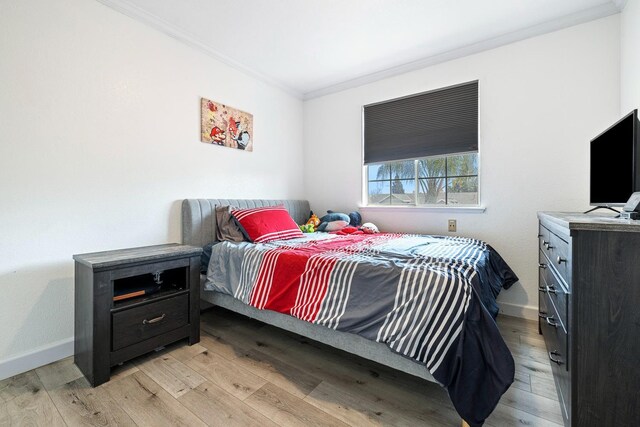 3232 Greenfield Ave, Clovis, CA 93611 - bedroom featuring ornamental molding and light wood-type flooring