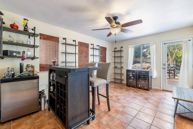 3232 Greenfield Ave, Clovis, CA 93611 - dining space with a ceiling fan, light tile patterned flooring, a textured ceiling, and beverage cooler