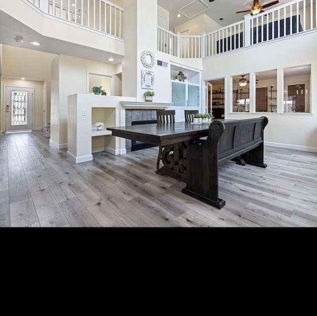 3232 Greenfield Ave, Clovis, CA 93611 - dining area with a ceiling fan, a high ceiling, wood finished floors, and recessed lighting