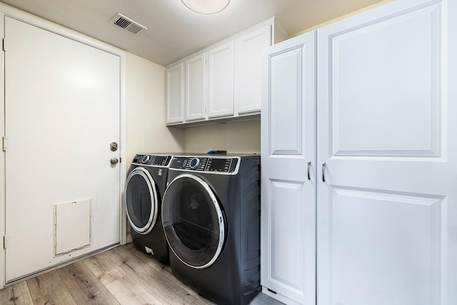 3232 Greenfield Ave, Clovis, CA 93611 - washroom featuring cabinet space, washing machine and clothes dryer, and light wood-style flooring