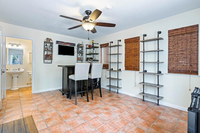 3232 Greenfield Ave, Clovis, CA 93611 - office featuring ceiling fan, tile patterned floors, and a bar