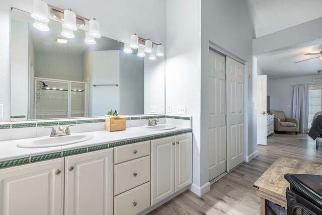 3232 Greenfield Ave, Clovis, CA 93611 - full bath featuring double vanity, a stall shower, wood finished floors, and ensuite bathroom