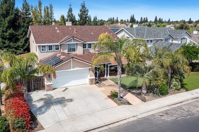 3232 Greenfield Ave, Clovis, CA 93611 - traditional-style home with stucco siding, concrete driveway, a garage, stone siding, and a chimney
