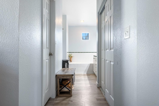 3232 Greenfield Ave, Clovis, CA 93611 - corridor featuring a textured wall, wood finished floors, and recessed lighting