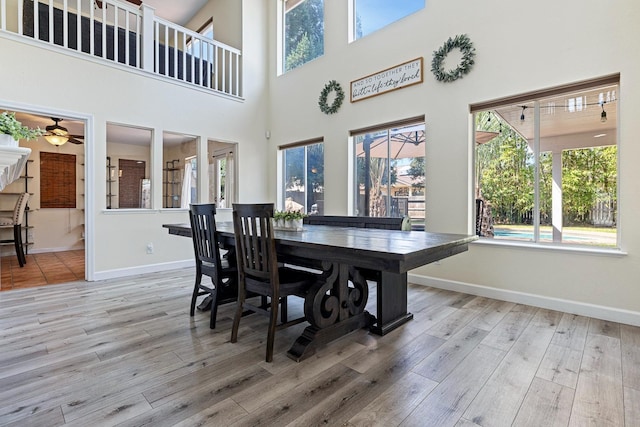3232 Greenfield Ave, Clovis, CA 93611 - dining space featuring wood finished floors, a ceiling fan, and a towering ceiling