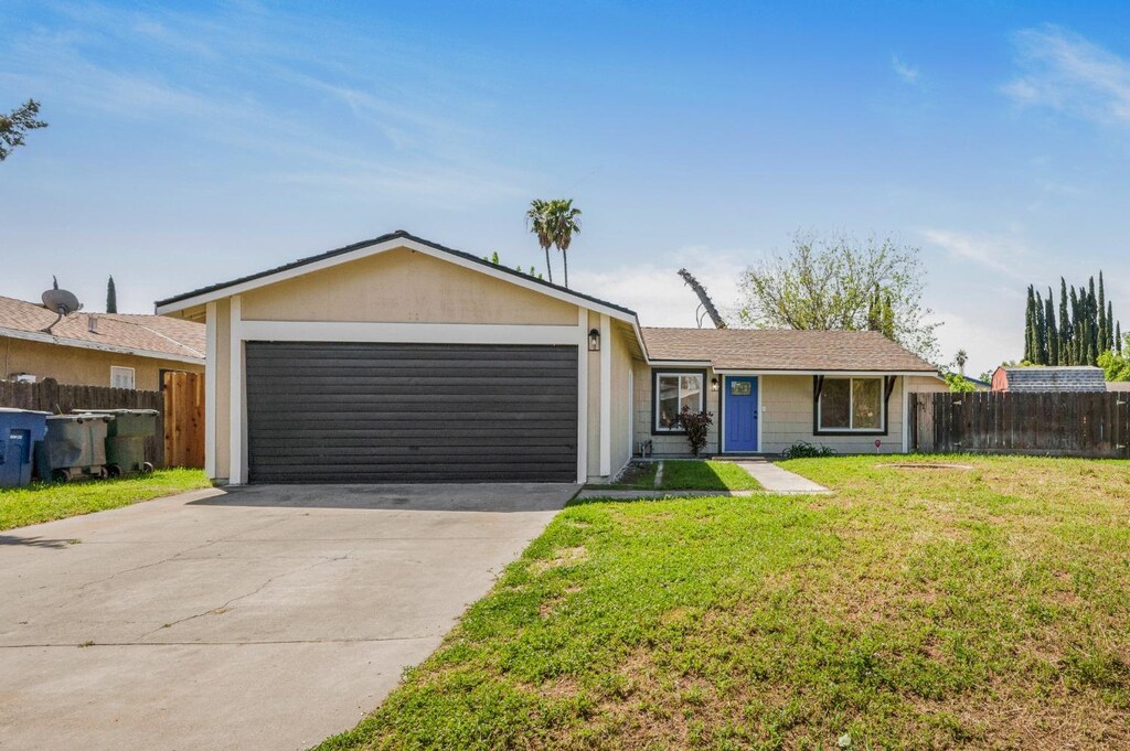 5934 E Dakota Ave, Fresno, CA 93727 - ranch-style home featuring a garage, driveway, a front yard, and fence