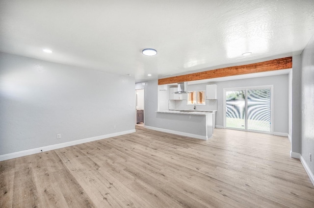 5934 E Dakota Ave, Fresno, CA 93727 - unfurnished living room with baseboards, light wood-style floors, and recessed lighting