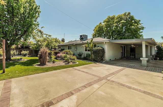 720 I St, Parlier, CA 93648 - view of front of property with a carport, driveway, a front lawn, and stucco siding