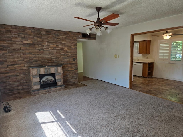 720 I St, Parlier, CA 93648 - unfurnished living room with ceiling fan, carpet flooring, a textured ceiling, and a fireplace