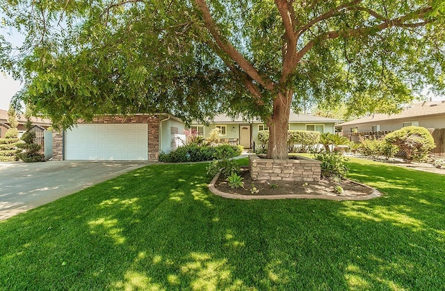 720 I St, Parlier, CA 93648 - view of front of house with stone siding, driveway, and a front yard
