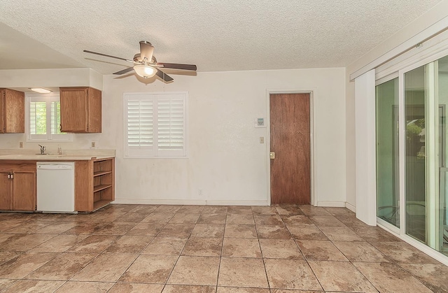 720 I St, Parlier, CA 93648 - kitchen with a ceiling fan, a textured ceiling, brown cabinetry, dishwasher, and light countertops