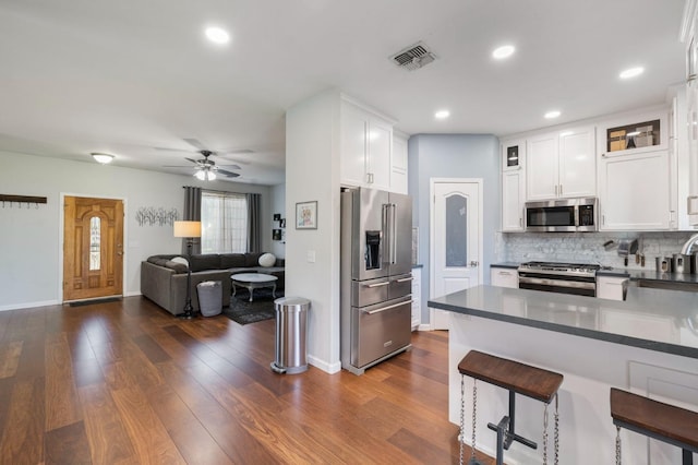 683 W Forest St, Kingsburg, CA 93631 - kitchen featuring visible vents, white cabinetry, dark countertops, and stainless steel appliances